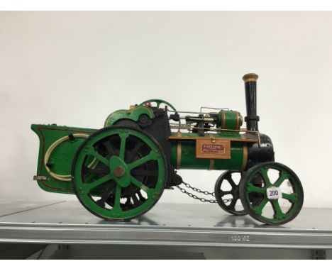 A hand built wooden model of a Traction Engine.
