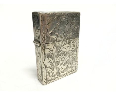 A silver cased petrol flint cigarette lighter with all-over engraved floral decoration.