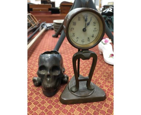 A small brass cased Art Nouveau style mantle clock together with a silvered china ceramic ashtray modelled as a Scull and Cro