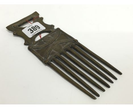 A ceremonial bronze comb, possibly Benin, Nigeria (museum style label attached).