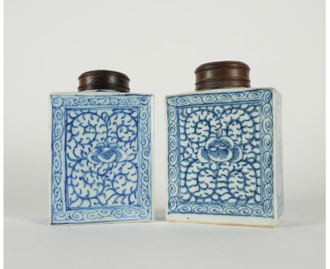 A NEAR PAIR OF CHINESE BLUE AND WHITE TEA CADDIES (4)19th century Of square section, each painted with lotus flowers and tend