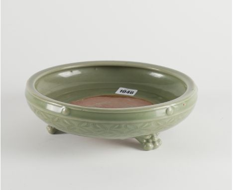 A CHINESE CELADON-GLAZED TRIPOD CENSERMing style but possibly later The centre of the interior unglazed and decorated with a 