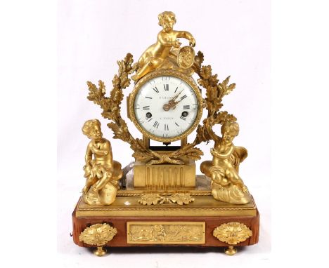 French ormolu mantel clock, surmounted with putto above a circular enamel Roman/Arabic dial inscribed Baillon Paris, supporte