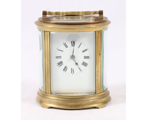 French oval brass carriage clock with Roman enamel dial, striking on a gong, 15cm.   CONDITION REPORT:  Two side panels have 