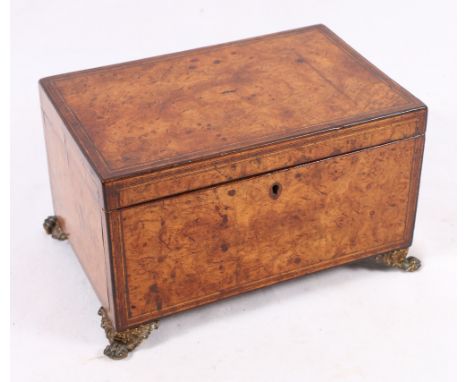 19th century burr tea caddy with two lift-out cannisters, raised on gilt metal supports.