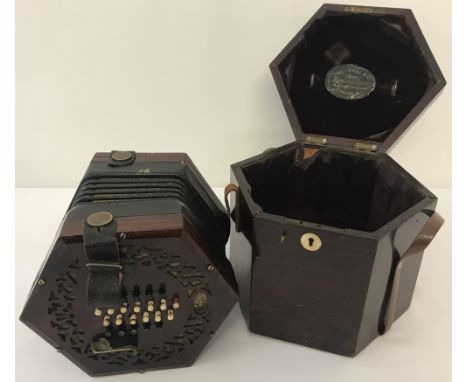 A vintage boxed 24 key Lachenal concertina with fretwork detail to speakers each end. Concertina marked Lachenal as well as i