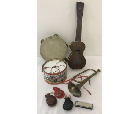 A box of assorted children's vintage musical instruments. To include: Chad Valley tin drum, a Mele Ukulele, tambourine and wo
