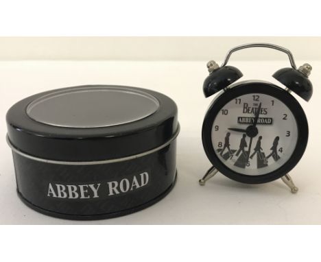 The Beatles "Abbey Road" Collectors miniature battery operated alarm clock. In original collectors tin, still with plastic ta