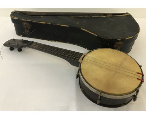 A vintage 4 string  banjo with original case. Makers badge missing, one string missing and others need attention.