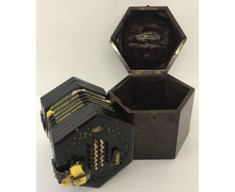 A vintage boxed Lachenal concertina, both box and instrument in need of repair. Fretwork detail to each end of concertina, 24