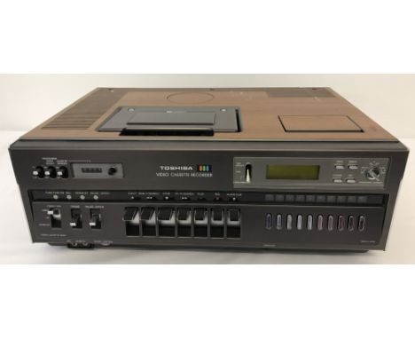 Toshiba V-5470B top loading video cassette recorder. Complete with original owners manual and quick reference card.