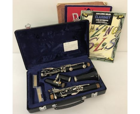 A hard cased Buffet Grampon &amp; Co clarinet together with a small collection of music books. Complete with 2 new reeds. Ser