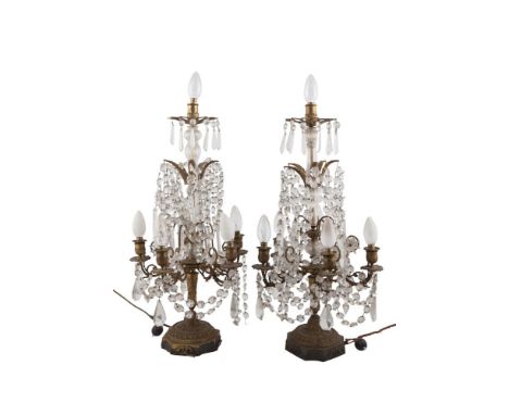 A PAIR OF FRENCH GILTMETAL AND CUT GLASS SEVEN LIGHT CANDELABRA, (converted to electricity) late 19th century, each with rais