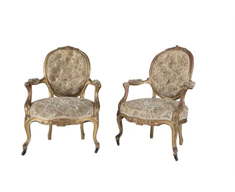 A PAIR OF CARVED GILTWOOD FRAMED FAUTEUILS, the oval button backs, armrests and seats covered in tapestry cloth, the crest ra