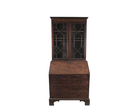 A GEORGE III MAHOGANY SLOPE FRONT BUREAU BOOKCASE, with dentil cornice above twin astragal glazed panel doors above writing s