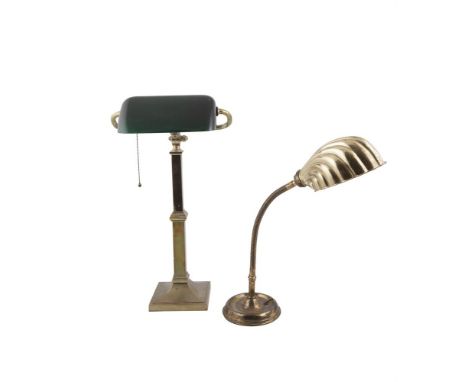 A BRASS ADJUSTABLE DESK LAMP WITH SHELL CAST SHADE, on circular base; together with a brass square column office desk lamp wi