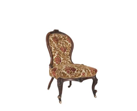 A VICTORIAN MAHOGANY FRAMED UPHOLSTERED LADIES CHAIR, with button back and padded seat, on carved cabriole legs and scroll fe