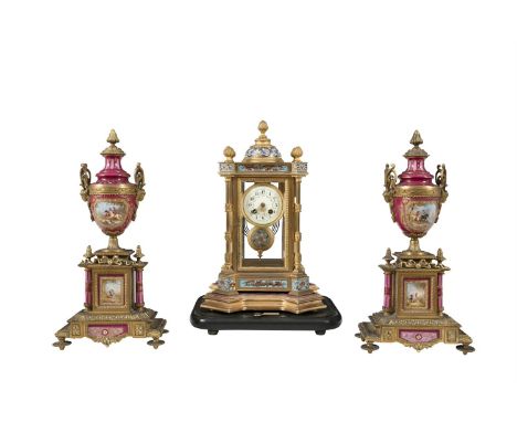 A FRENCH GILT BRASS CASED MANTLE CLOCK, of architectural form, the bevelled clear glass all-round panels within turned column