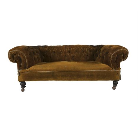 A VICTORIAN UPHOLSTERED CHESTERFIELD SOFA, the buttoned roll back, sides and seat covered in russet velvet and raised on turn