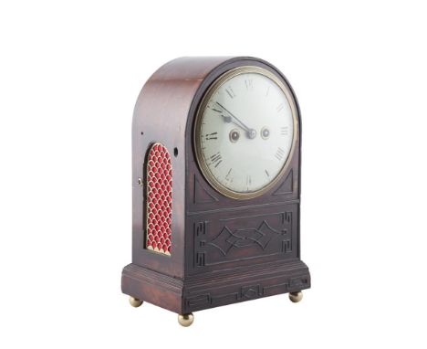 AN IRISH REGENCY MAHOGANY CASED BRACKET CLOCK, the arched top enclosing a white circular dial, inked with Roman numerals abov