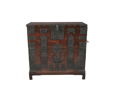 A KOREAN HARDWOOD BANDAJI CAMPAIGN CHEST, of rectangular form, fitted cast iron carrying handles and applied with tracery mou