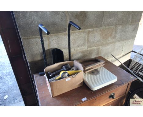 A box of battery torches, personal scales, tennis racquet etc