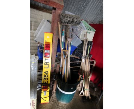 A plastic bin and quantity of long-handled tools