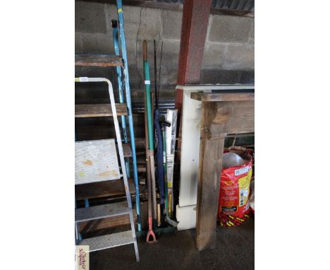 A quantity of long handled garden tools and a fishing rod