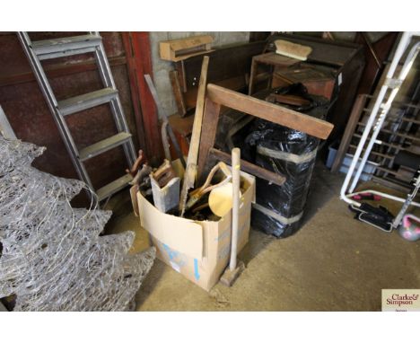 A box of tools including saws, T-squares and a sledge hammer