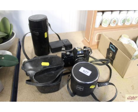 A Nikon EM camera; flash unit and two lenses