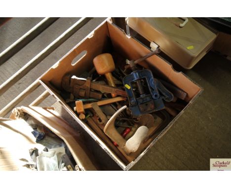 A box of tools including pipe vice, steel shoe last etc