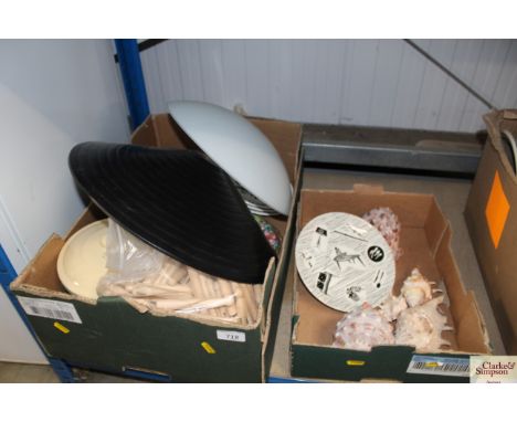 Two boxes containing seashells, wooden pegs, light shades, enamel items and a single Home Maker patterned plate 