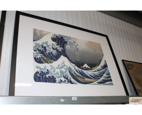 An Oriental print depicting boats in heavy seas