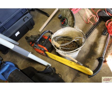 A bucket containing a quantity of chain, wire rope, and a chainsaw for spares and repairs