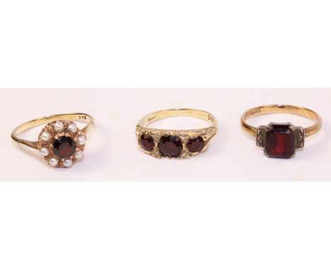 Gold garnet and seed pearl cluster ring stamped 9ct, gold three stone garnet ring hallmarked 9ct and  one other