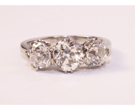 Three stone old cut diamond platinum ring, the centre stone of approx 1.25 carat with either side two diamonds of approx 0.75