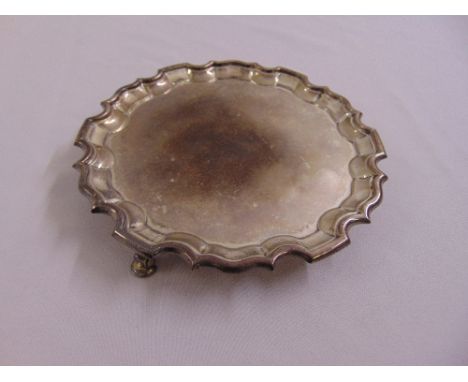 A silver circular salver, Chippendale border on three scroll feet, Birmingham 1904