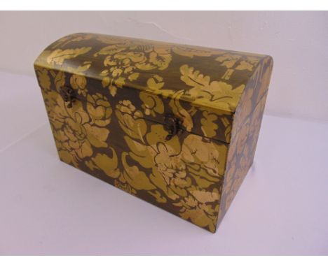 A rectangular painted wooden trunk with hinged arched cover