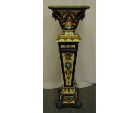 A Rorstrand ceramic majolica style plant stand, tapering rectangular on quatrefoil base, decorated with masks, leaves and scr