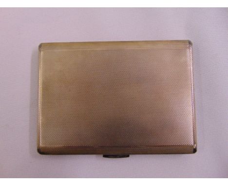 A silver engine turned rectangular cigarette case