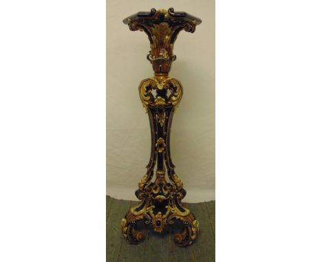 A ceramic plant stand, profusely decorated with stylised leaves and scrolls on three scroll supports, A/F