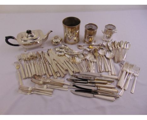 A quantity of silver plate to include a teapot, wine bottle coasters and flatware