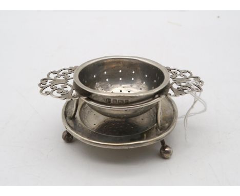 An Edwardian silver tea strainer and stand, by Harrison Brothers &amp; Howson, Sheffield 1911, the strainer with pierced twin