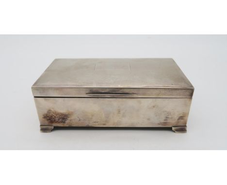 An Elizabeth II silver cigarette box, by H Bros, Birmingham, engine turned with a blank cartouche,&nbsp; 1975, 16 x 8.5cm Con