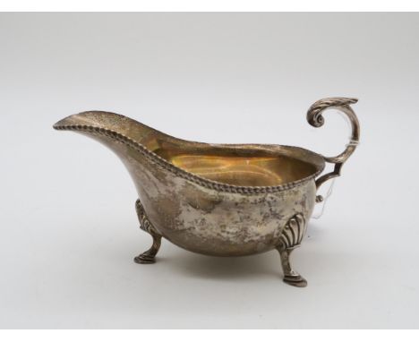 A silver sauce boat, by Harrison Brothers &amp; Howson, London 1931, in the George III style, with a flying acanthus scroll h