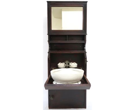 A LATE VICTORIAN MAHOGANY SHIPS CABIN WASHSTAND&nbsp; with rectangular mirror over open shelves over fall front compartment e