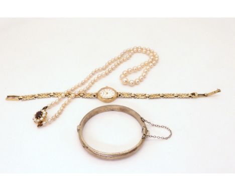 A 9ct gold ladies watch, weight with mechanism 8.5gms, a string of pearls with a 9ct garnet and pearl clasp and a silver chil