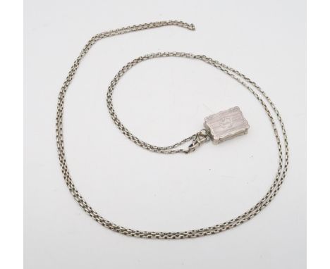 A Victorian silver vinaigrette, by Edward Smith, Birmingham 1852, of shaped form, with engine turned banded decoration, monog