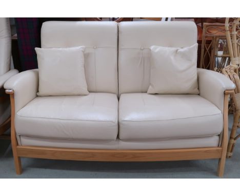 A contemporary elm and beech framed Ercol Gina two seater sofa with cream leather upholstery, 94cm high x 153cm wide x 90cm d