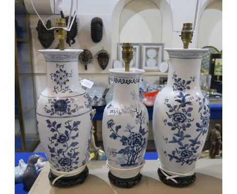 Three Chinese blue and white lamp garnitures, on hardwood bases (3) Condition Report:Available upon request